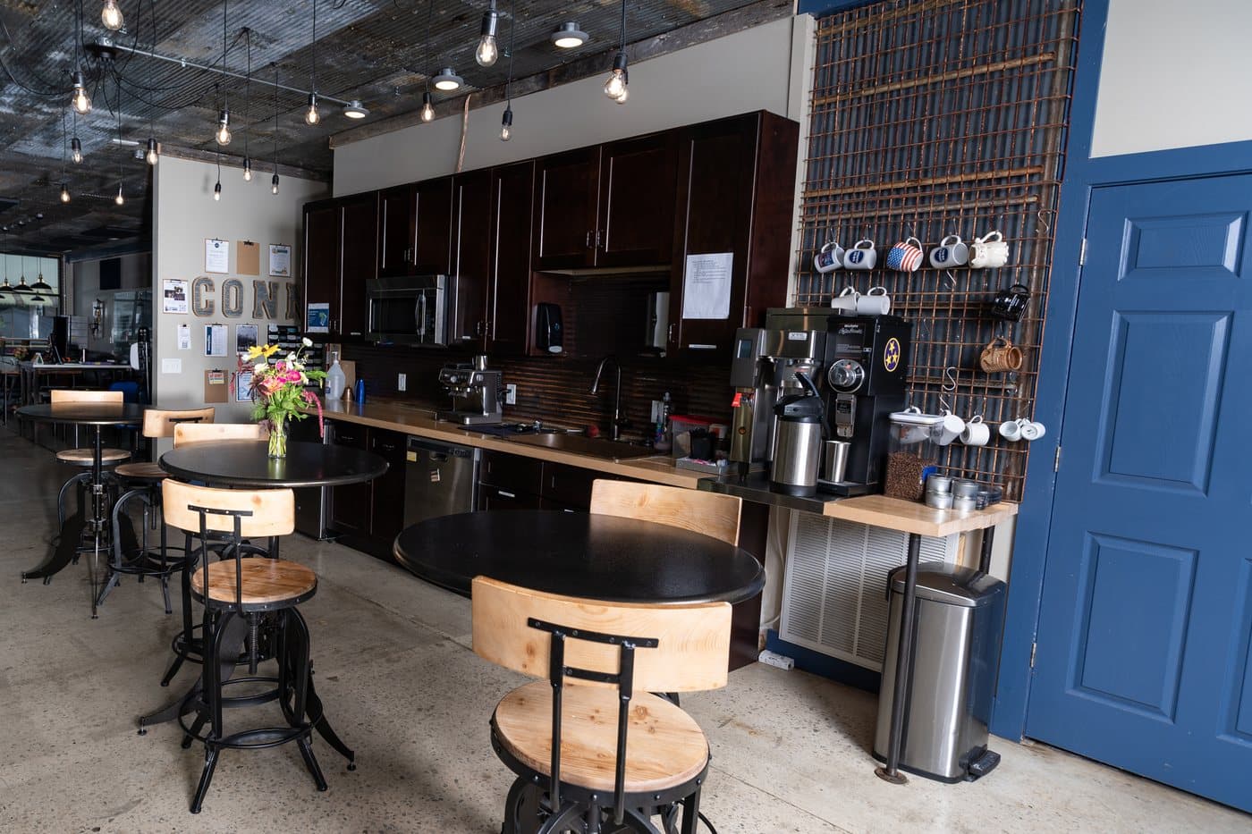 The coffee bar and kitchen with stools and high tables