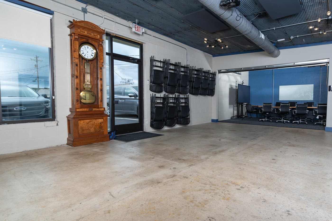 The open event hall with roll-up doors and polished concrete