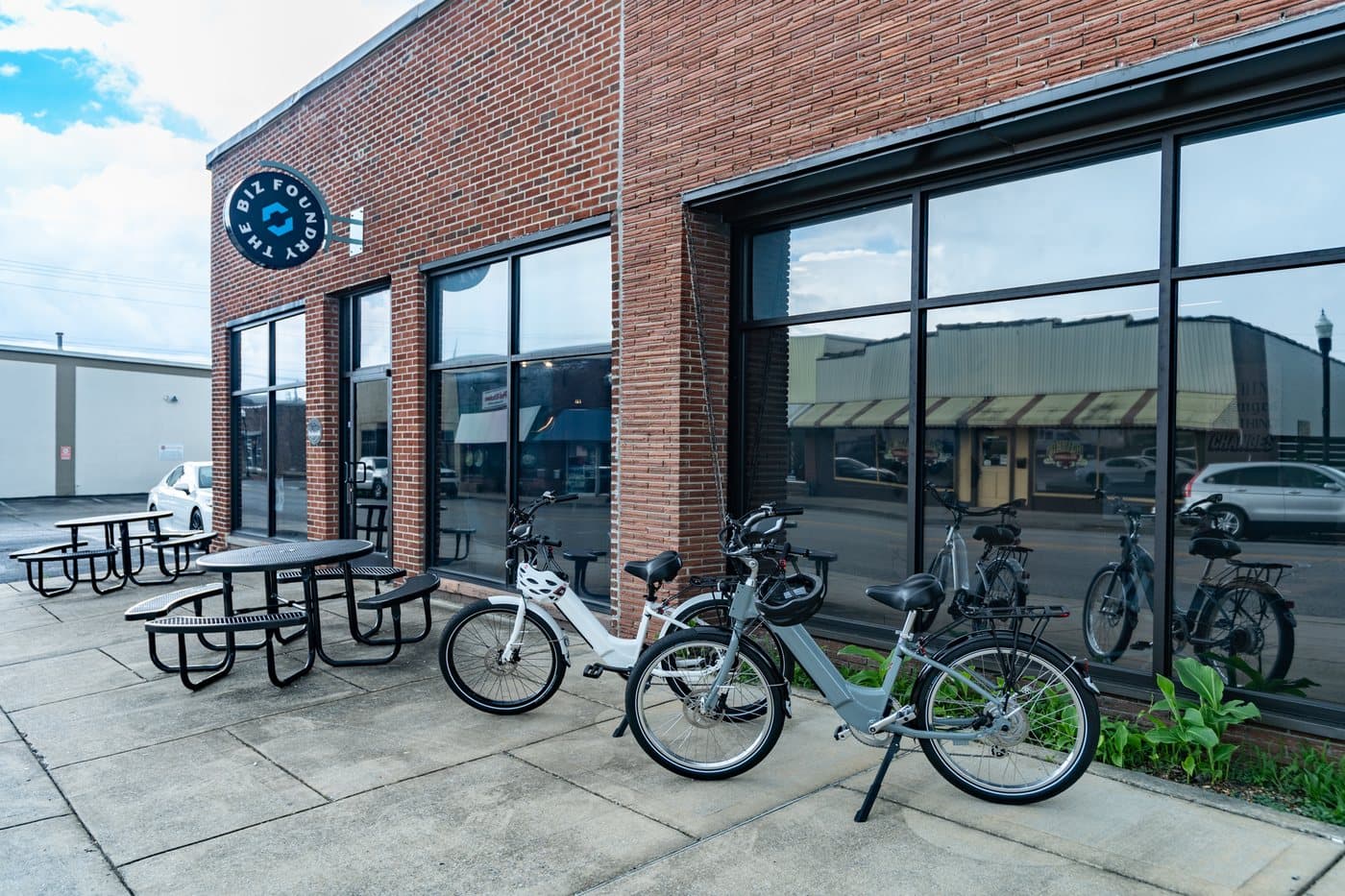 Picnic tables and bike racks on the patio outside WorkBase