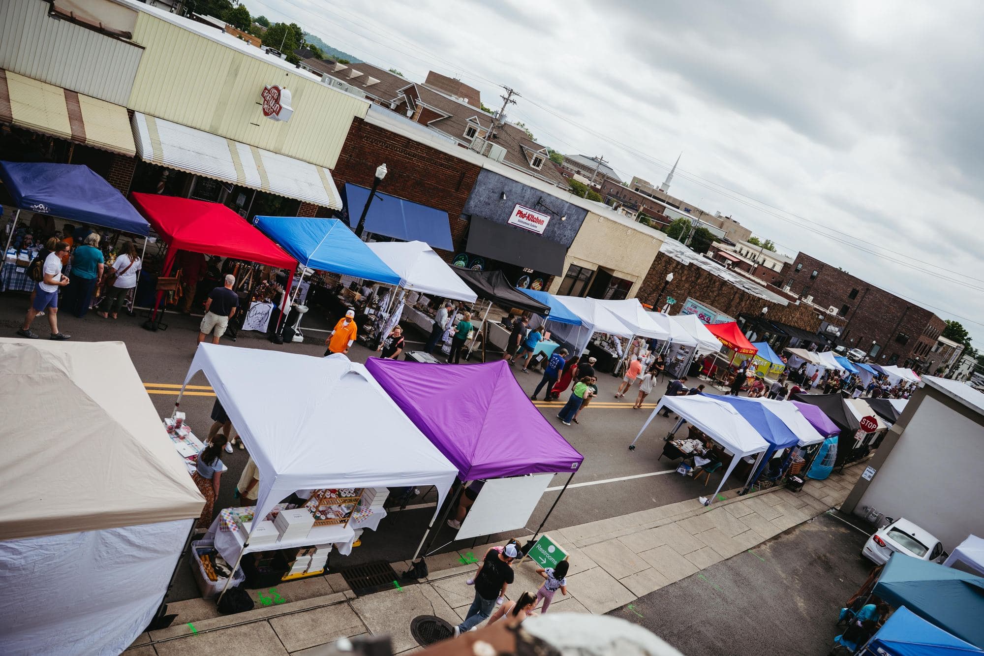 Vendor tents lining Cedar Avenue at the market