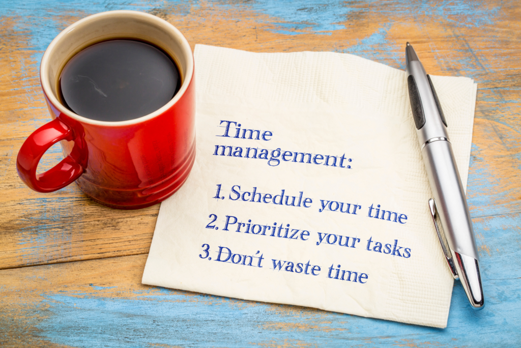 Desktop with coffee cup and piece of paper listing time management tips