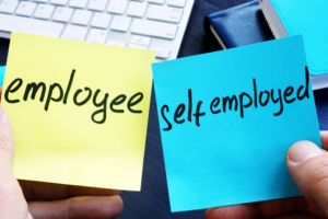 photo of hands holding 2 sticky notes and one reads employee and the other self-employed